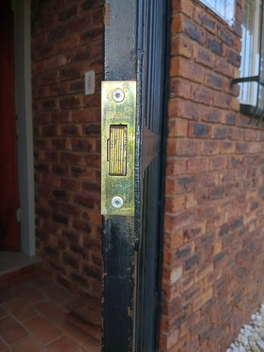 New strike plate and mortice lock fitted to a door frame